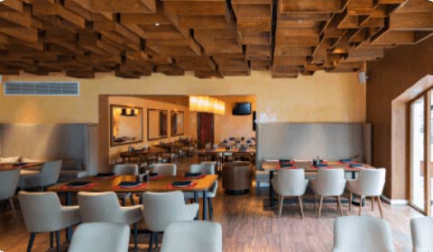 Image of a cafeteria with empty chairs and tables to portray the Panera Bread company